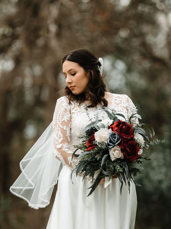 bride posing for her bridal portraits with bouquet in hand at Texas Old Town - Sage Hall in Kyle, TX