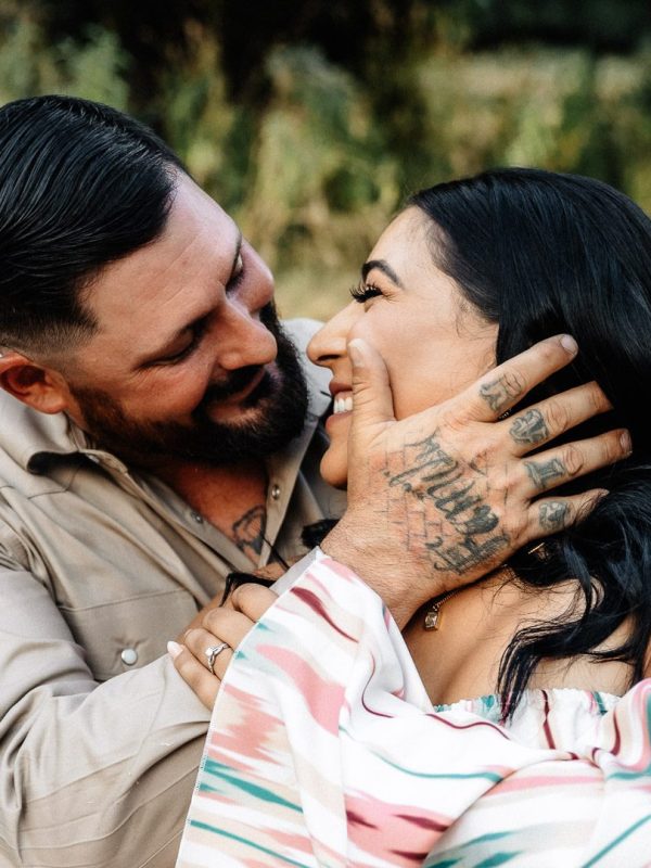 romantic couple gazes into each others eyes during engagement photo session at Dos Palomas Ranch wedding venue in Boerne, Texas